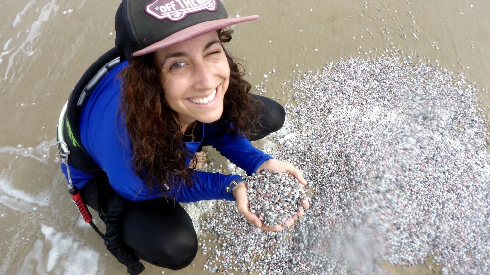 The kite session is over. Marta shows the camera a heap of small shells. Vung Tau kitespot - Vietnam