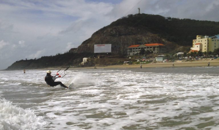 9 kitesurfing in Vung Tau beach with the Christ statue up there